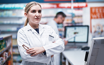 Buy stock photo Shot of a young pharmacist working in a pharmacy