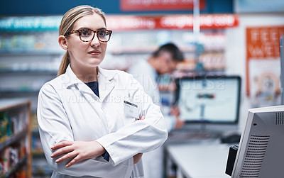 Buy stock photo Shot of a young pharmacist working in a pharmacy