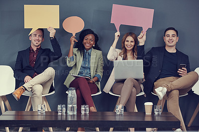 Buy stock photo Shot of a group of businesspeople holding up speech bubbles and using different wireless devices while waiting in line for an interview