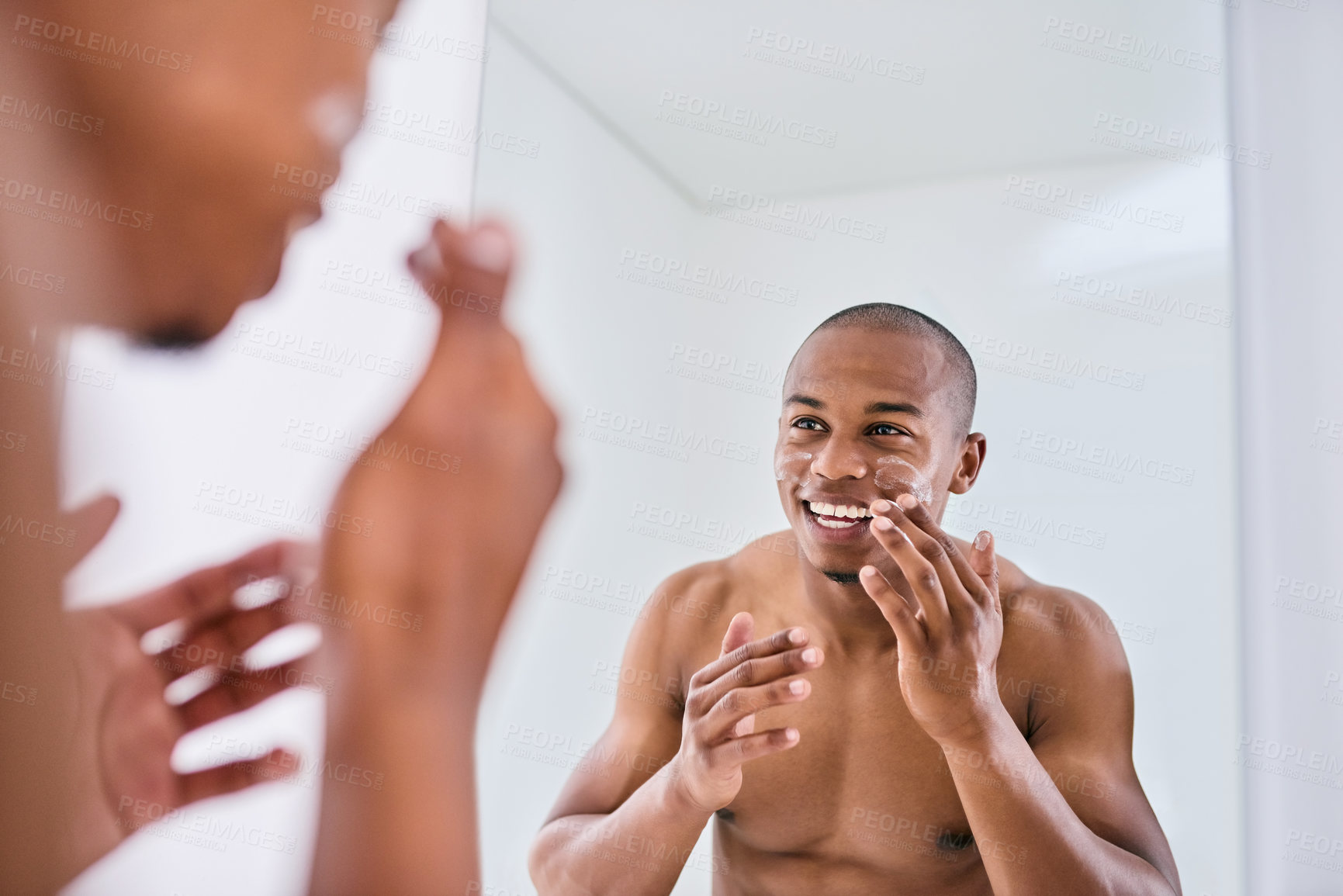 Buy stock photo Happy man, skincare and lotion with mirror for grooming, facial or morning routine at home. Young, male person or reflection with smile, moisturizer or cream for soft skin or dermatology in bathroom