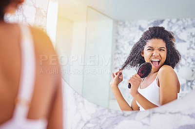 Buy stock photo Shot of an attractive young woman singing while brushing her hair in the bathroom at home