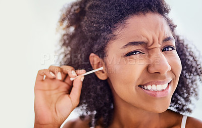 Buy stock photo Face, African woman and cotton swab for hygiene on portrait with self care and cleaning. Female person, home and removing earwax for germs, dirt and bacteria for wellness, routine and grooming