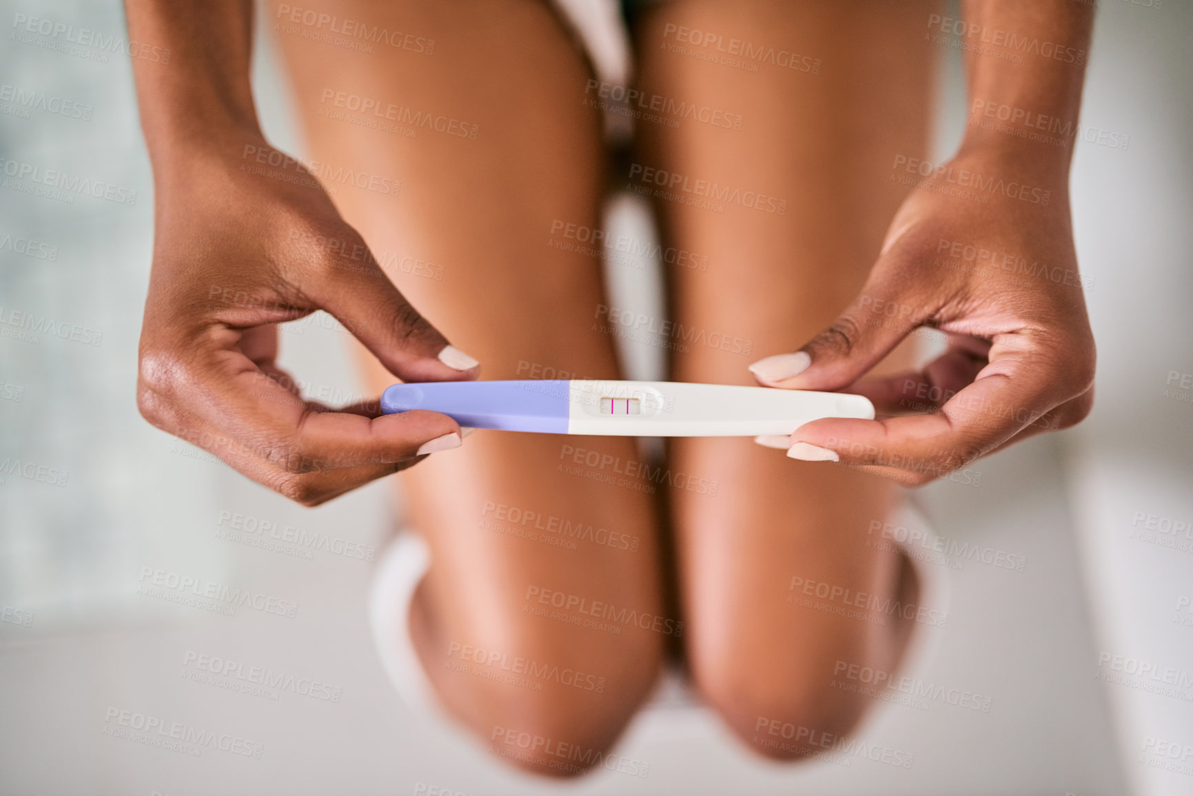 Buy stock photo Hands, female person and closeup of a pregnancy test by a mother in the bathroom of her home. Maternity, motherhood and zoom of woman with pregnant stick with results in her modern house or apartment