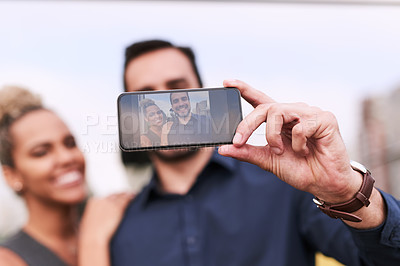 Buy stock photo Closeup shot of two colleagues taking a selfie together outside an office