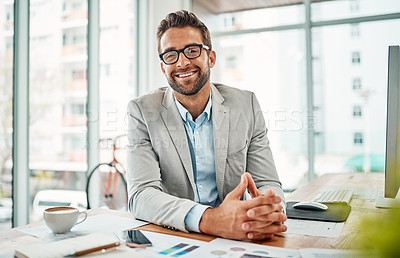 Buy stock photo Portrait of a handsome young businessman sitting in an office