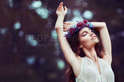 Buy stock photo Shot of a beautiful young woman wearing a floral head wreath outdoors