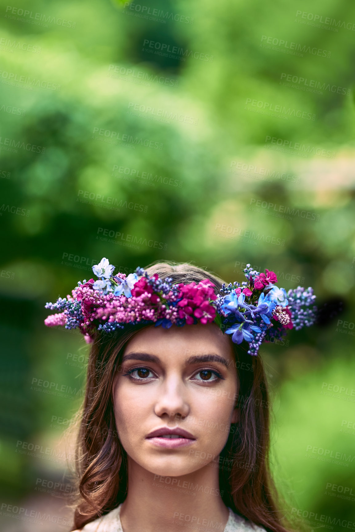 Buy stock photo Cropped shot of a beautiful young woman wearing a floral head wreath posing in nature
