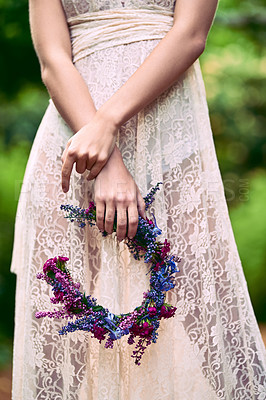 Buy stock photo Cropped shot of an unrecognizable woman holding a floral head wreath posing in nature