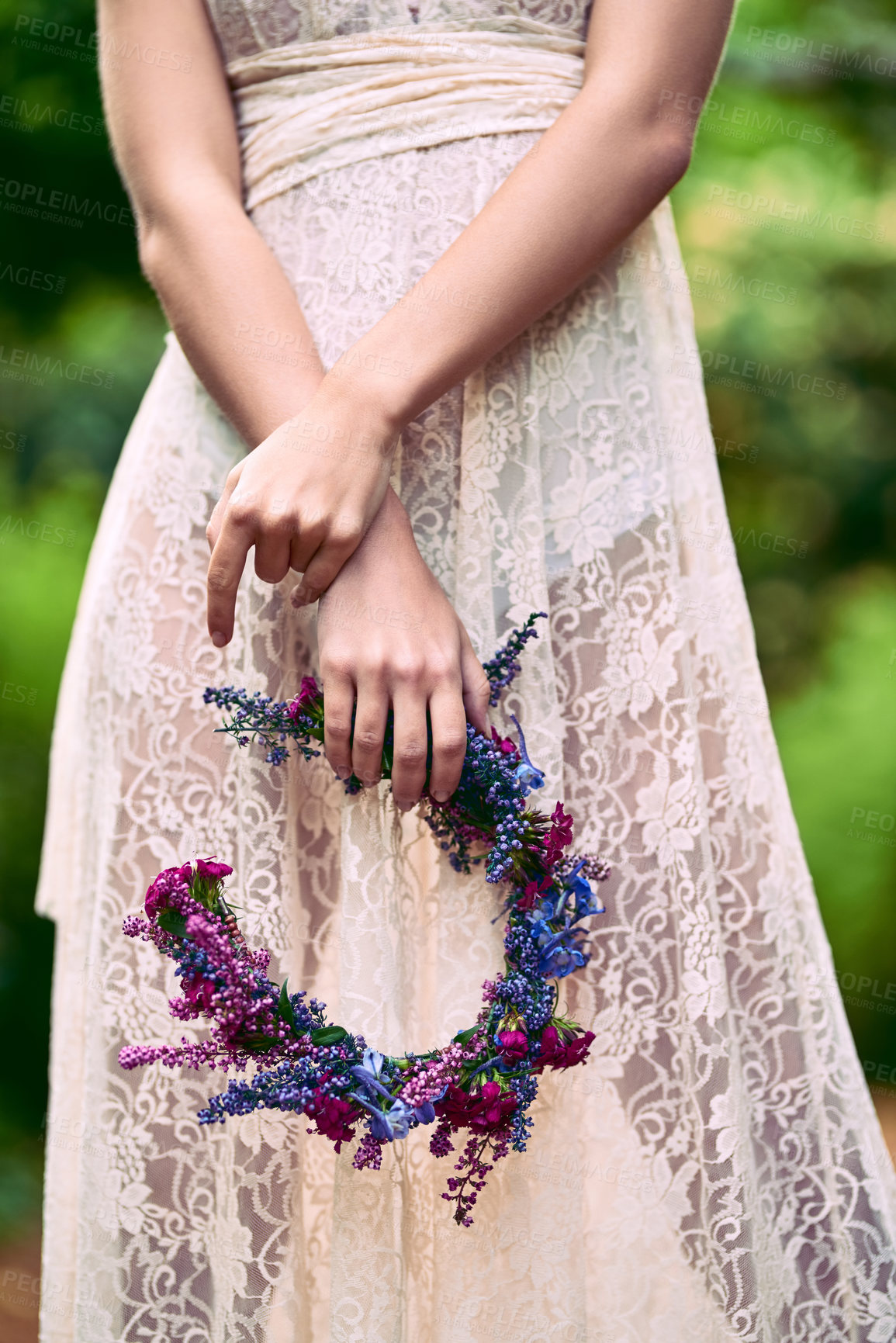Buy stock photo Cropped shot of an unrecognizable woman holding a floral head wreath posing in nature