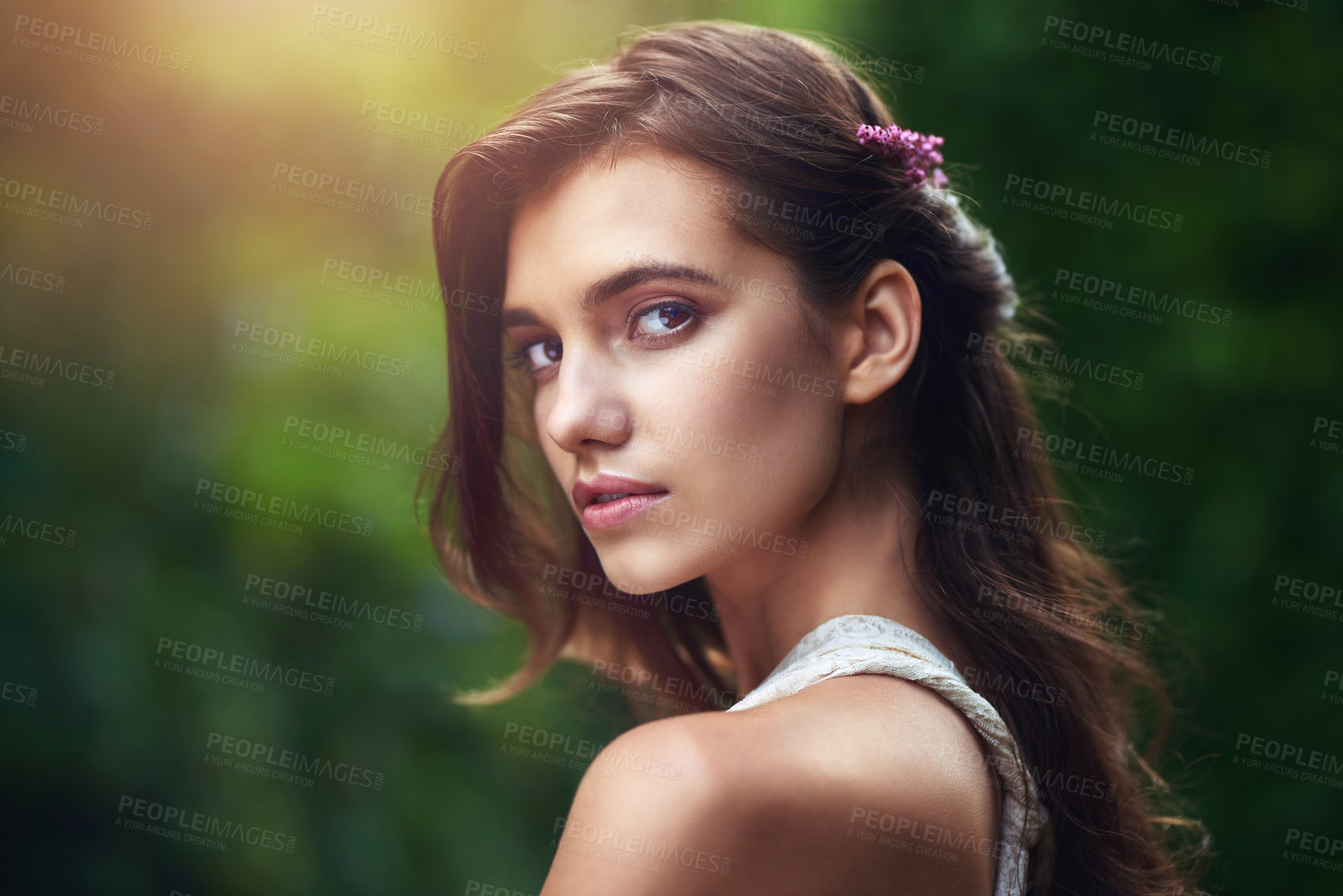 Buy stock photo Cropped shot of a beautiful young woman posing in nature