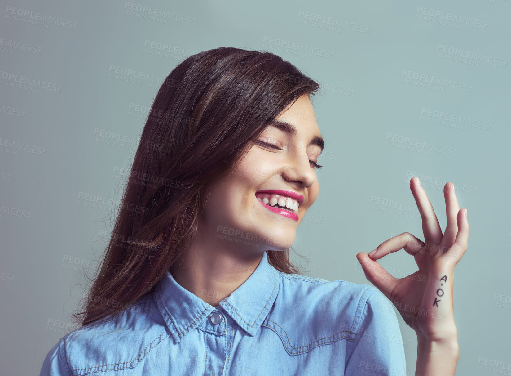 Buy stock photo Studio shot of an attractive young woman making an 