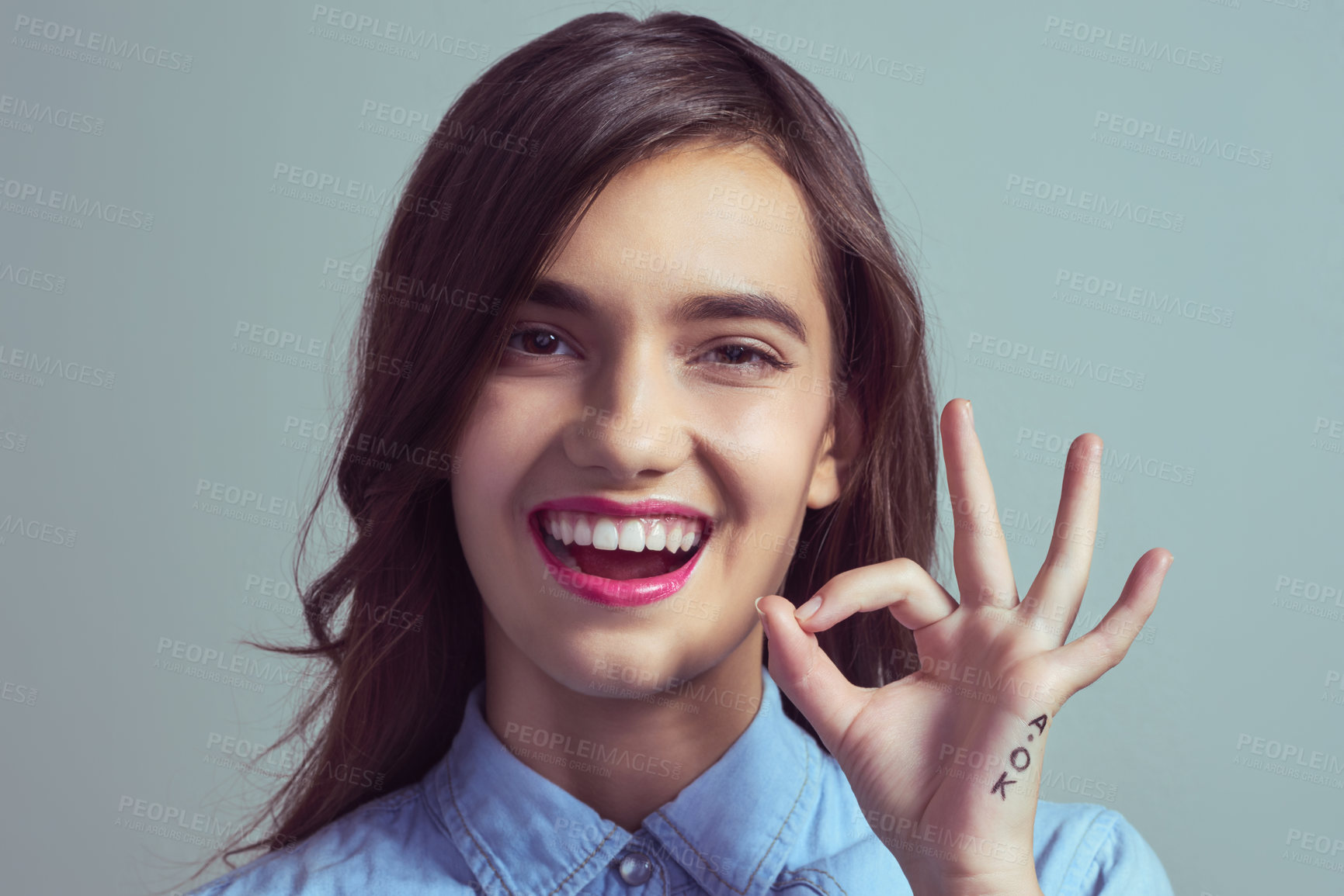 Buy stock photo Studio portrait of an attractive young woman making an 