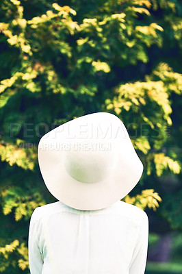 Buy stock photo Rearview shot of a woman wearing a stylish hat outdoors