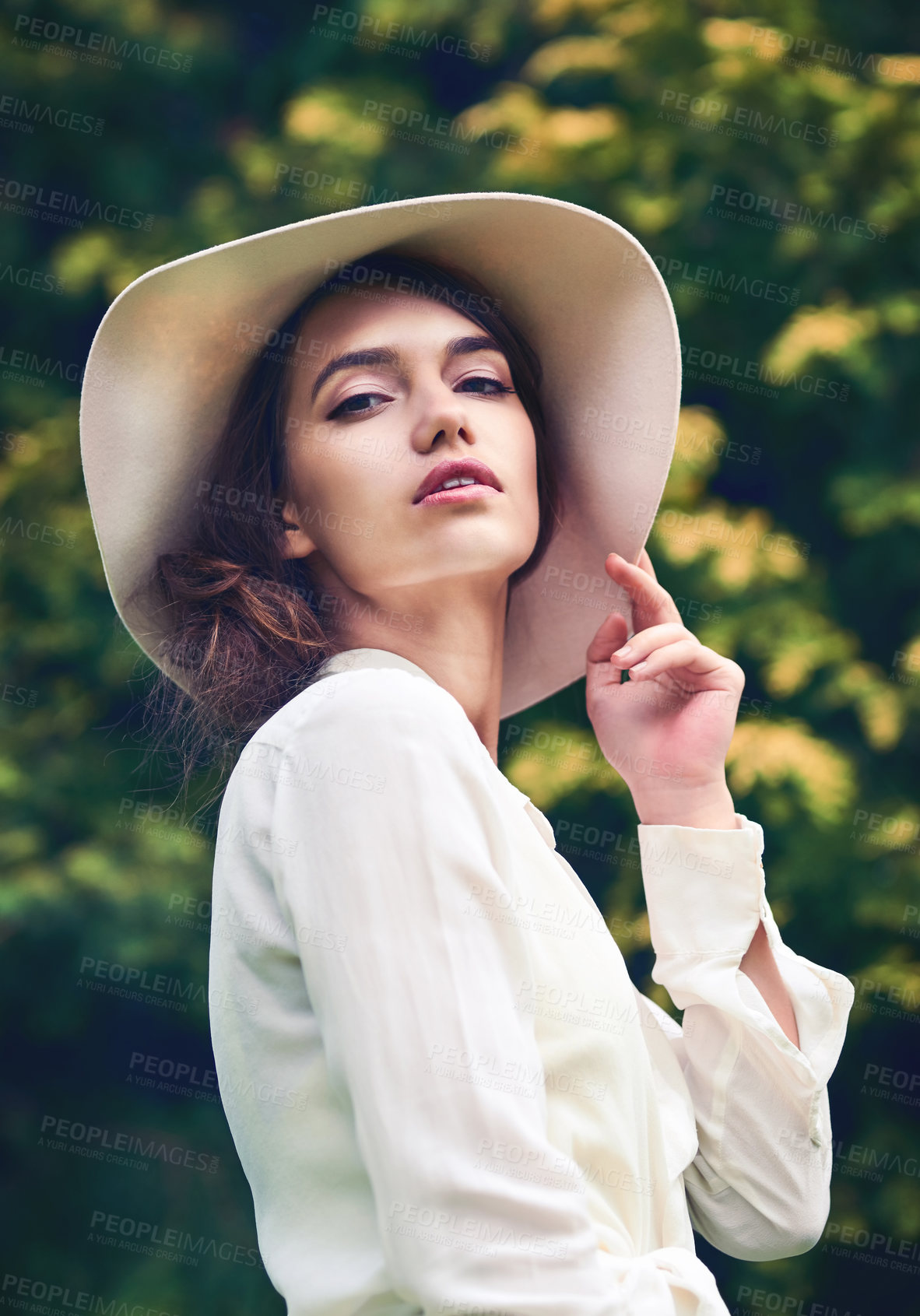 Buy stock photo Portrait of an attractive young woman wearing a stylish hat outdoors