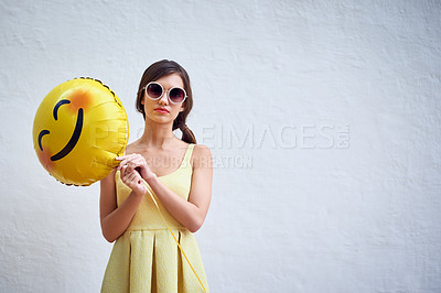 Buy stock photo Woman, balloon and sunglasses by wall background in summer with emoji, fashion and mock up space for party. Gen z girl, event and portrait with icon, smiley and yellow dress for spring celebration