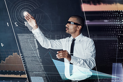 Buy stock photo Shot of a handsome young businessman using a digital interface