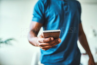 Buy stock photo Closeup shot of an unrecognizable man using a cellphone