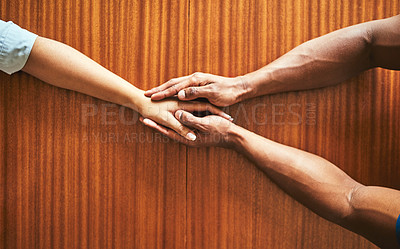 Buy stock photo High angle shot of two unrecognizable people holding hands