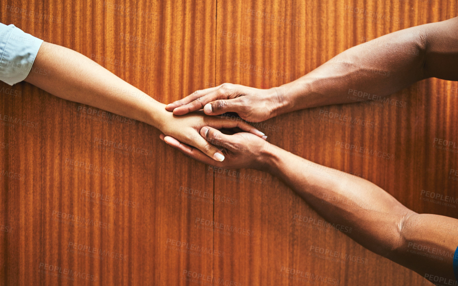 Buy stock photo High angle shot of two unrecognizable people holding hands