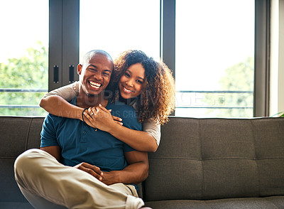 Buy stock photo Portrait of a happy young couple relaxing together at home