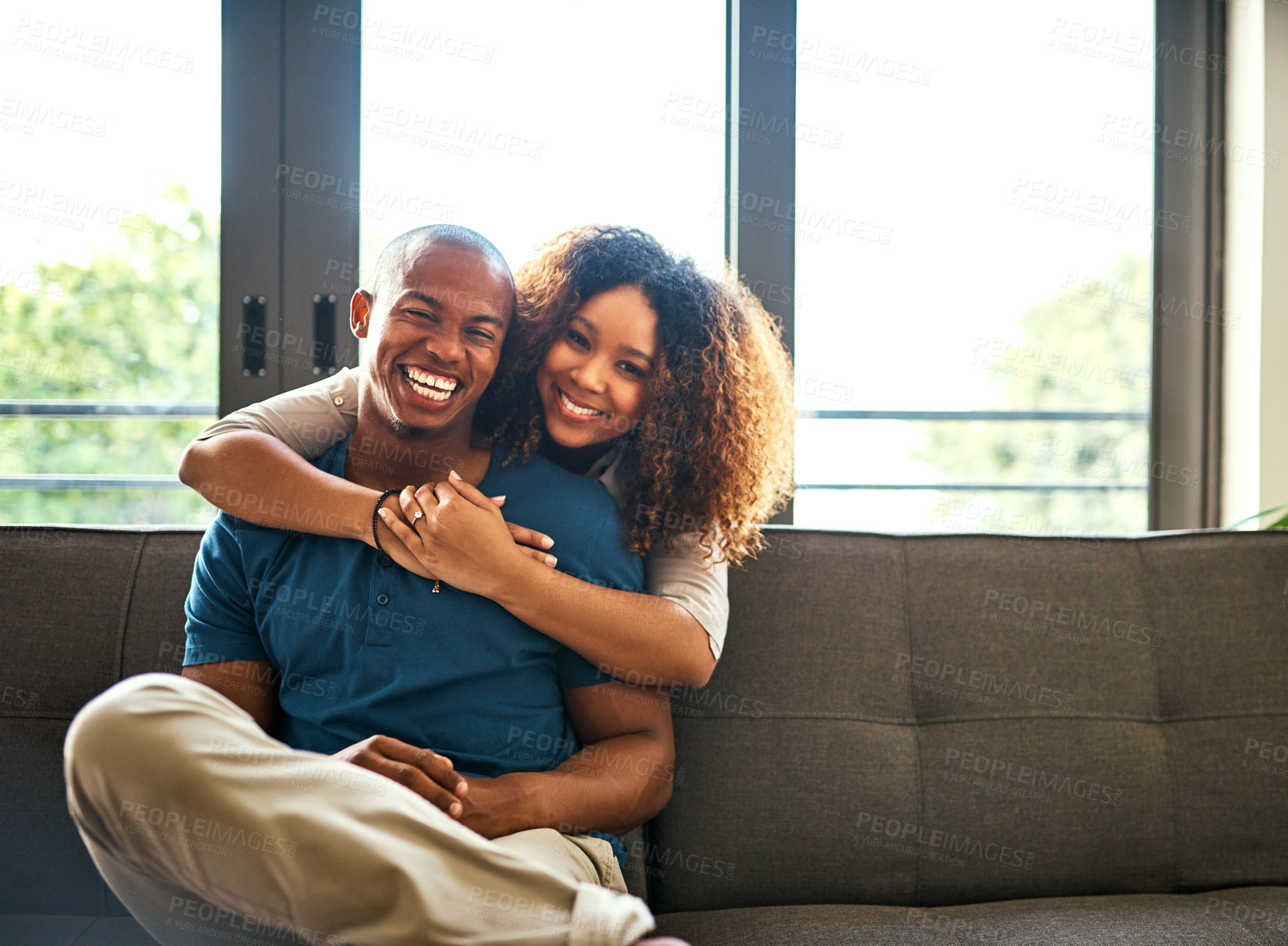 Buy stock photo Portrait of a happy young couple relaxing together at home