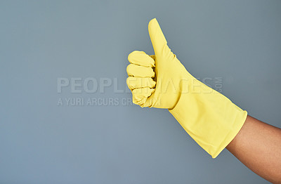 Buy stock photo Studio shot of an unrecognizable woman wearing rubber gloves showing thumbs up against a gray background