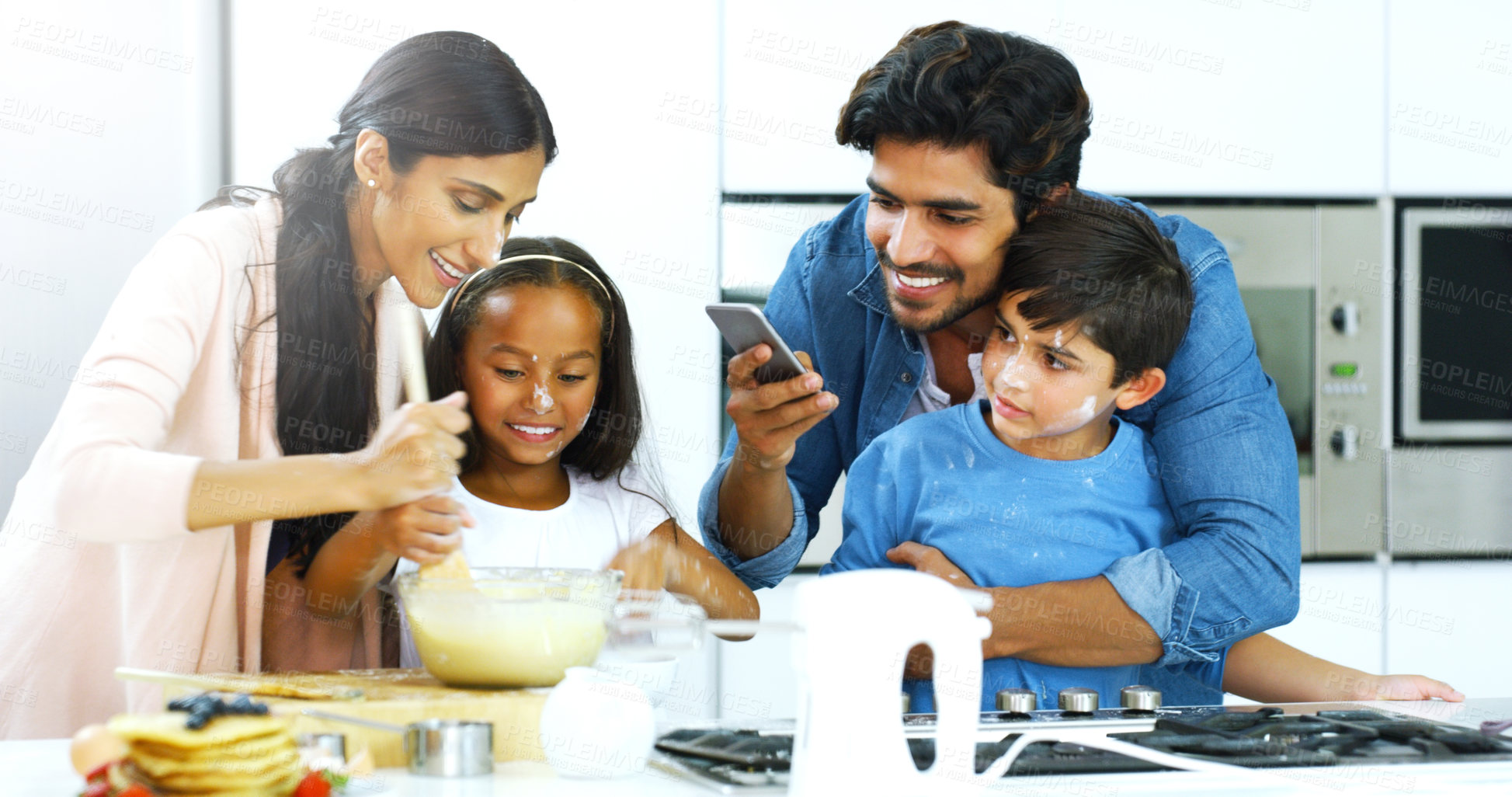 Buy stock photo Family, phone and cooking in house for breakfast, pancakes and social media with teaching or development. Indian people, mobile and happy in kitchen for brunch, learning or memory with live streaming