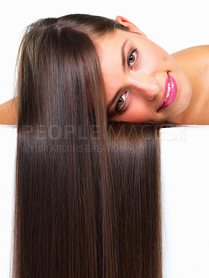 Buy stock photo Studio portrait of a beautiful young woman posing against a white background