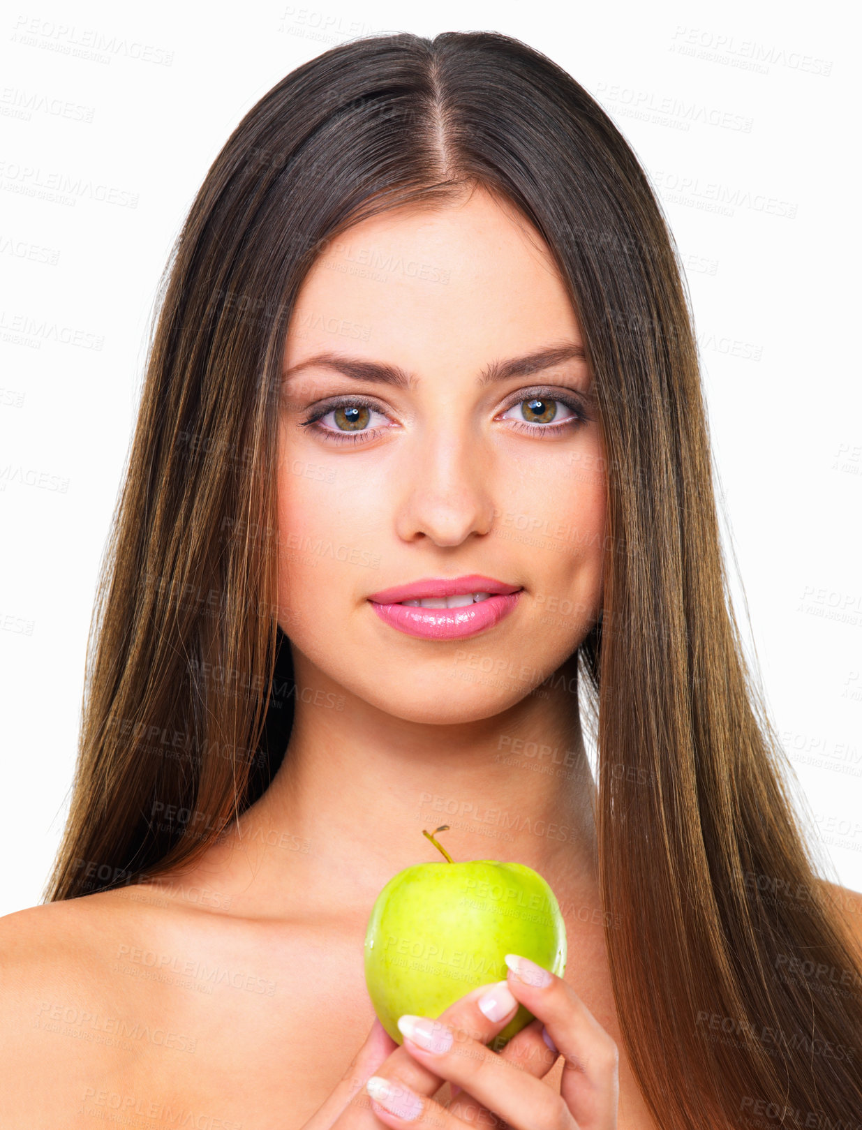 Buy stock photo Studio portrait of a beautiful young woman eating an apple against a white background