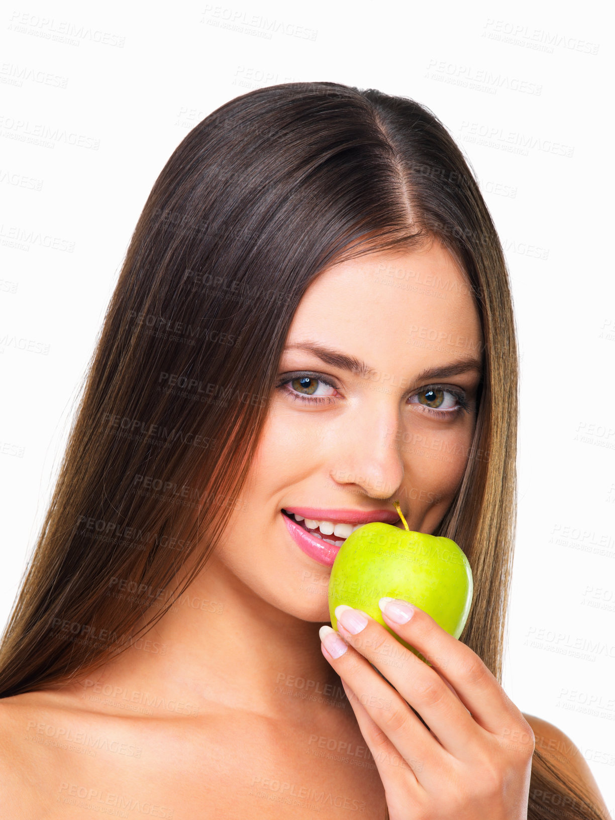 Buy stock photo Studio portrait of a beautiful young woman eating an apple against a white background