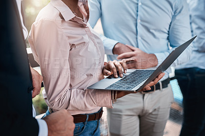 Buy stock photo Closeup shot of an unrecognizable group of businesspeople working together on a laptop outdoors
