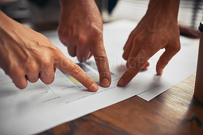 Buy stock photo Cropped shot of unrecognizable businesspeople working on paperwork together in the office