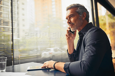 Buy stock photo Cropped shot of a mature businessman on a call in the office