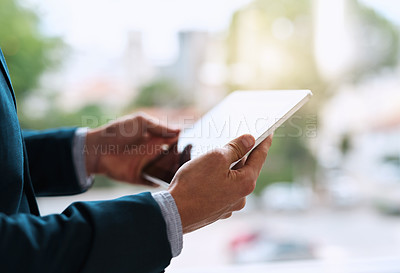 Buy stock photo Closeup shot of an unrecognizable businessman using a digital tablet in an office