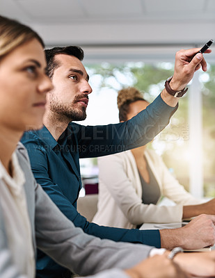 Buy stock photo Shot of a group of businesspeople listening to a presentation in an office