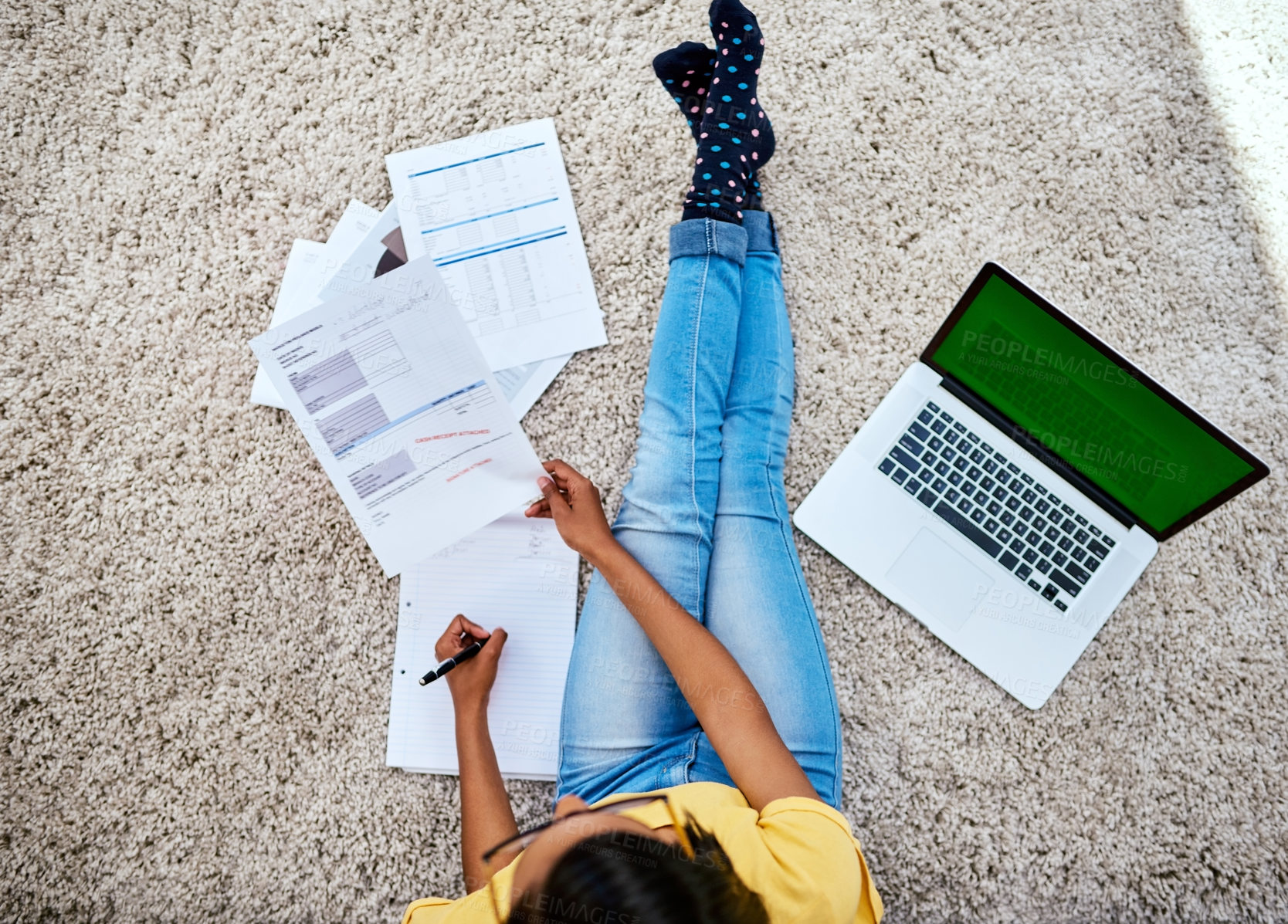 Buy stock photo High angle shot of an unrecognizable teenage girl doing schoolwork at home