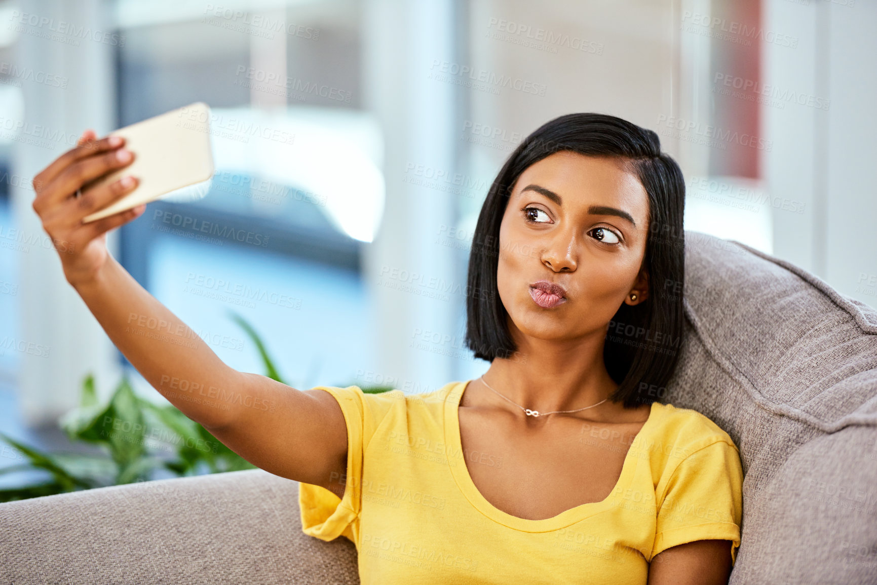 Buy stock photo Shot of a teenage girl taking a selfie at home