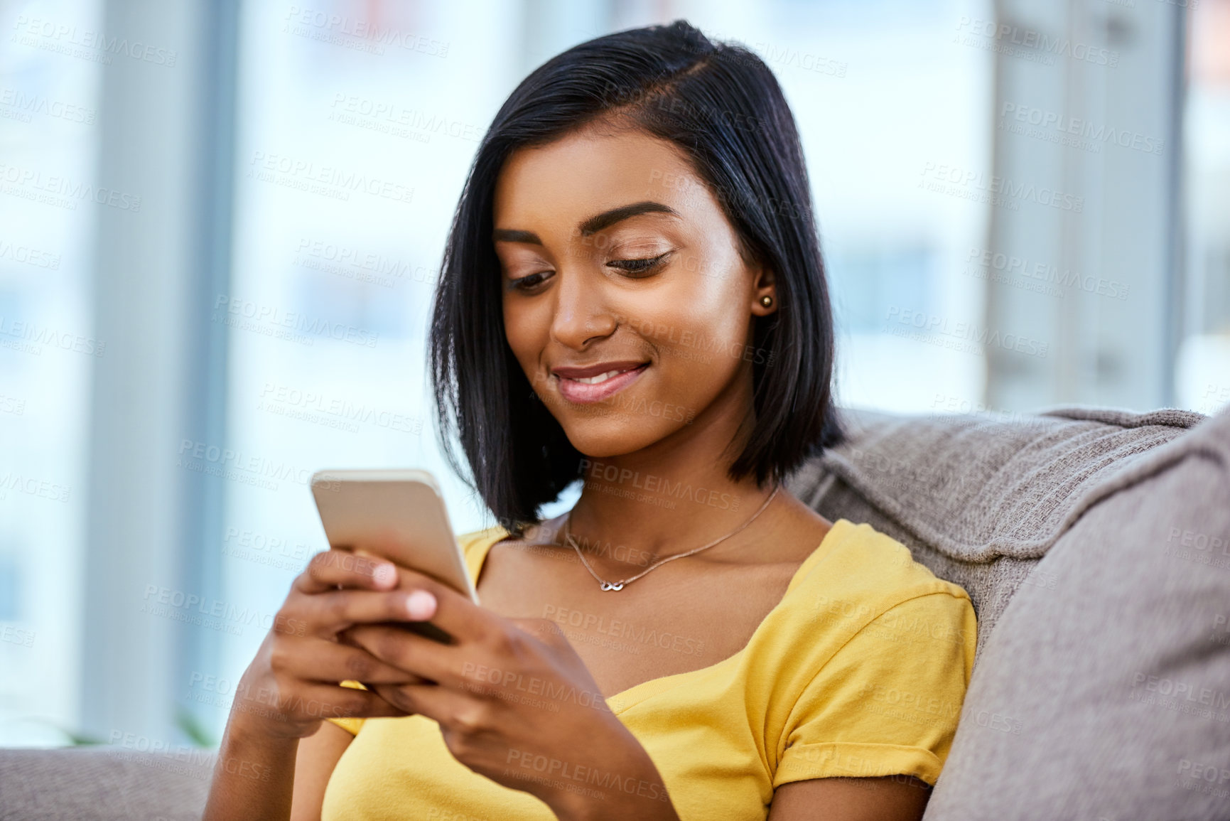 Buy stock photo Shot of a teenage girl using a cellphone at home