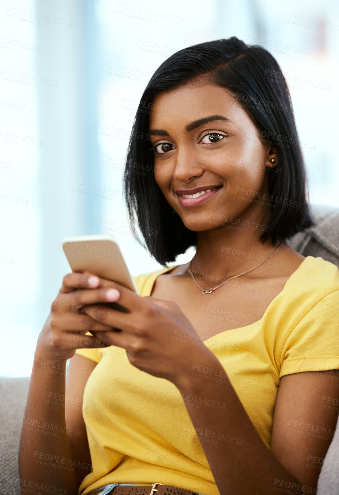 Buy stock photo Portrait of a teenage girl using a cellphone at home