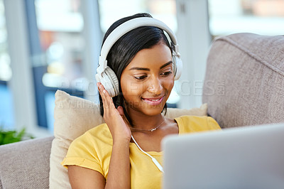 Buy stock photo Girl, happy and headphones with laptop on sofa at home on streaming platform, website and internet. Female person, woman and smile with watching movies, film and entertainment for fun and break