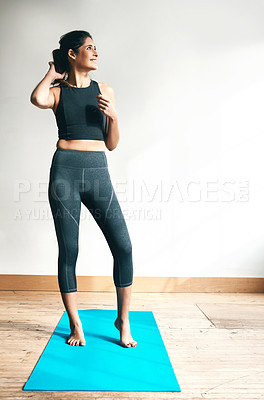 Buy stock photo Shot of an attractive young woman exercising at home