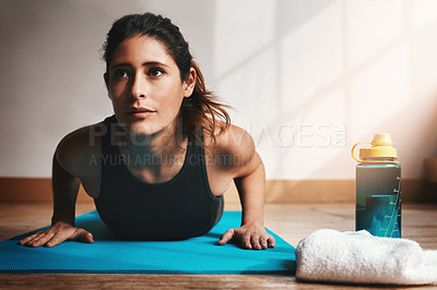 Buy stock photo Shot of an attractive young doing pushups at home