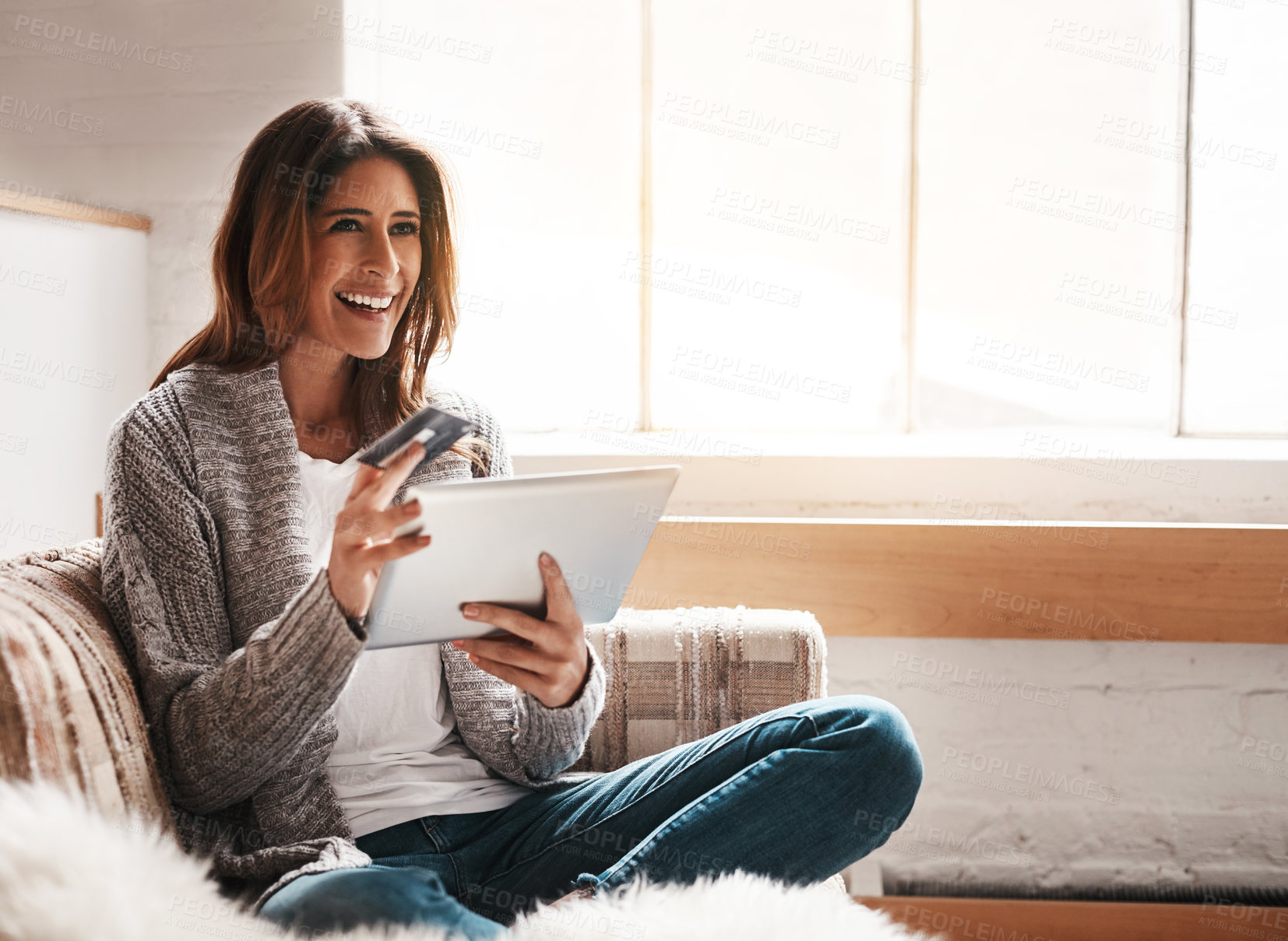 Buy stock photo Idea, tablet and credit card with a woman online shopping while sitting on a sofa in the living room at home. Ecommerce, finance and online banking with a young female customer thinking in her house