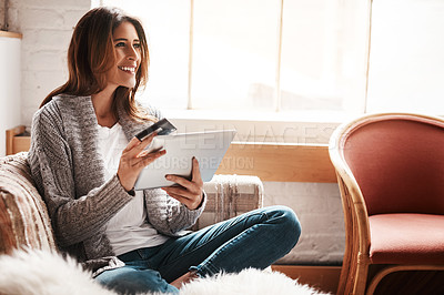 Buy stock photo Thinking, tablet and credit card with a woman online shopping on a sofa in the living room of her home. Ecommerce, finance and fintech banking with a young female online customer in her house