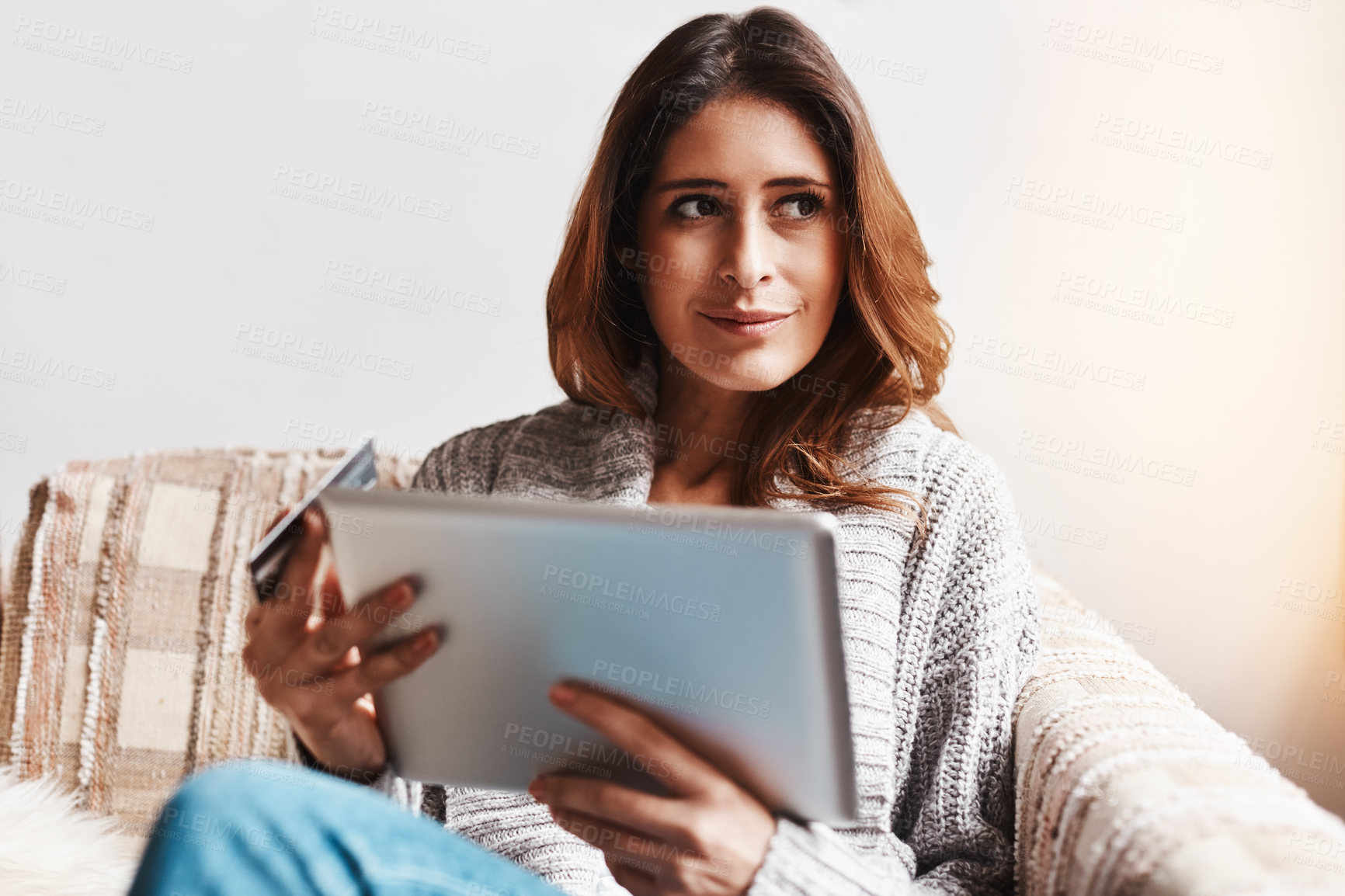 Buy stock photo Idea, tablet and online customer with a woman shopping using a credit card on a sofa in the living room at home. Ecommerce, finance and internet banking with a young female shopper in her house