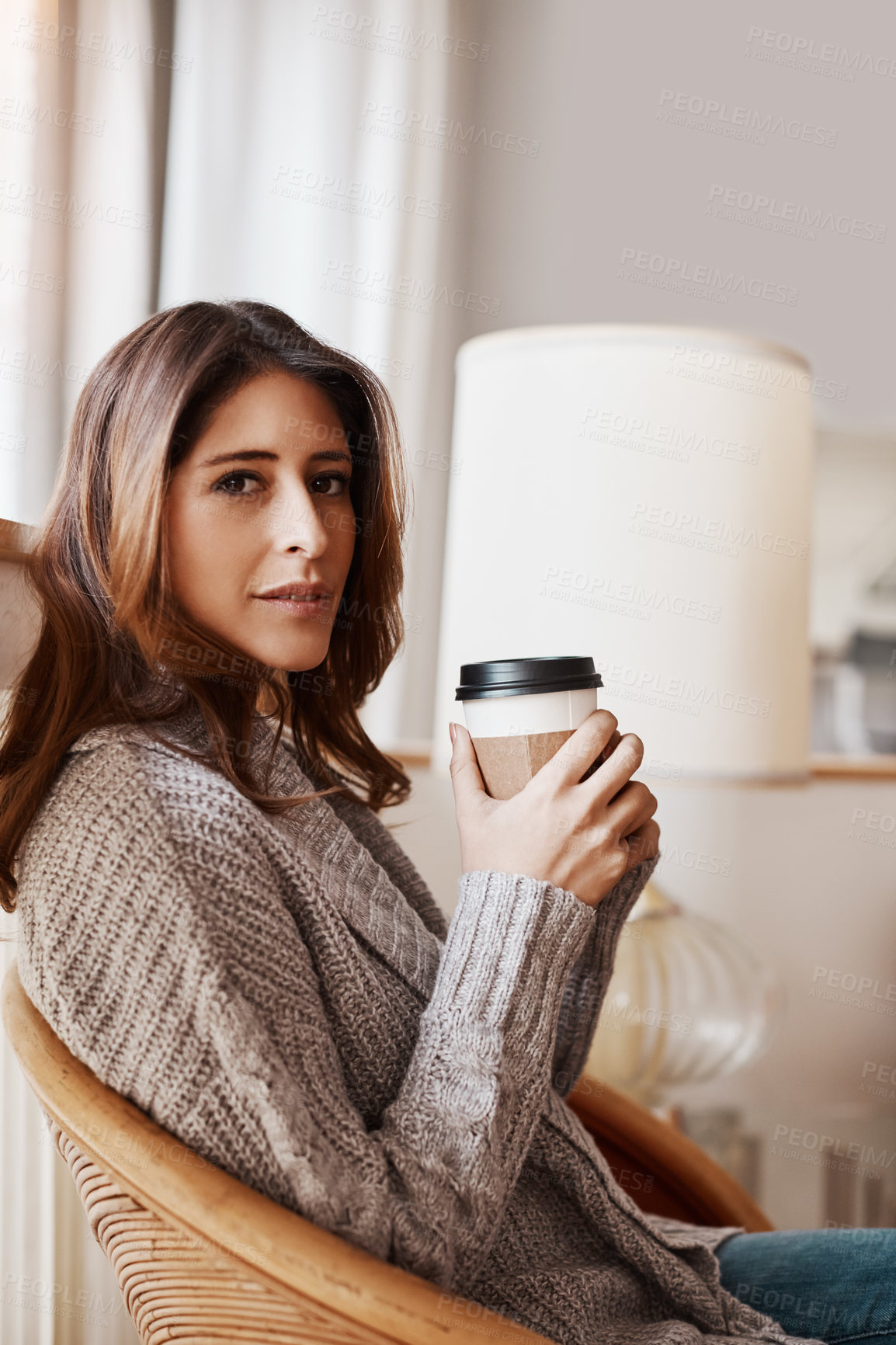 Buy stock photo Portrait of an attractive young woman relaxing at home with a cup of coffee