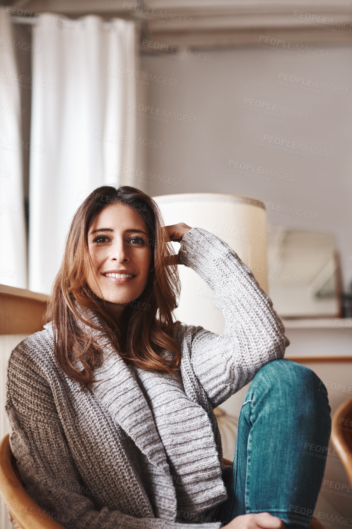 Buy stock photo Portrait of an attractive young woman relaxing on a chair at home