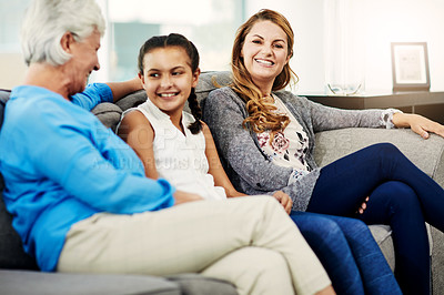 Buy stock photo Cropped shot of a senior woman sitting on the sofa at home with her daughter and granddaughter