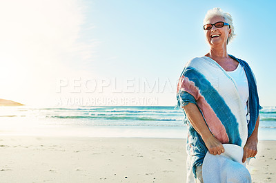 Buy stock photo Cropped shot of a senior woman visiting the beach on a summer's day