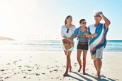 Buy stock photo Full length shot of a senior woman spending the day at the beach with her daughter and granddaughter